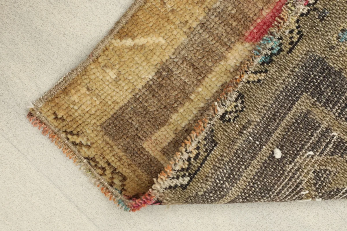 Close-up of the low wool pile and cotton foundation, showing the rug's texture and construction.