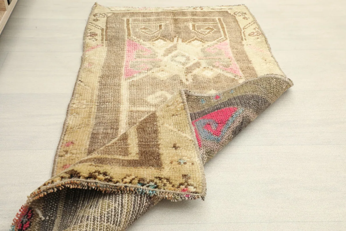 The rug folded to show flexibility and the reverse side of the hand-knotted wool and cotton.