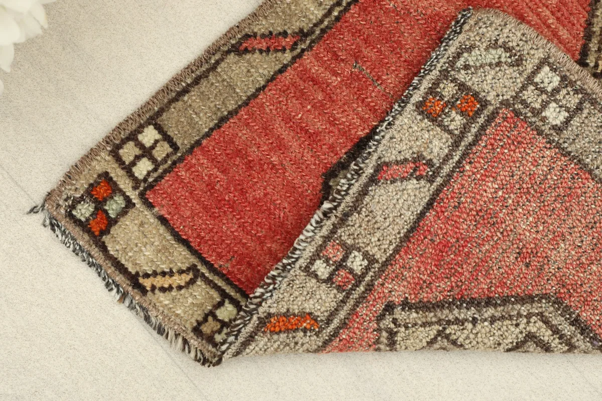Rug folded to display the thickness of the hand-knotted wool pile and the construction.
