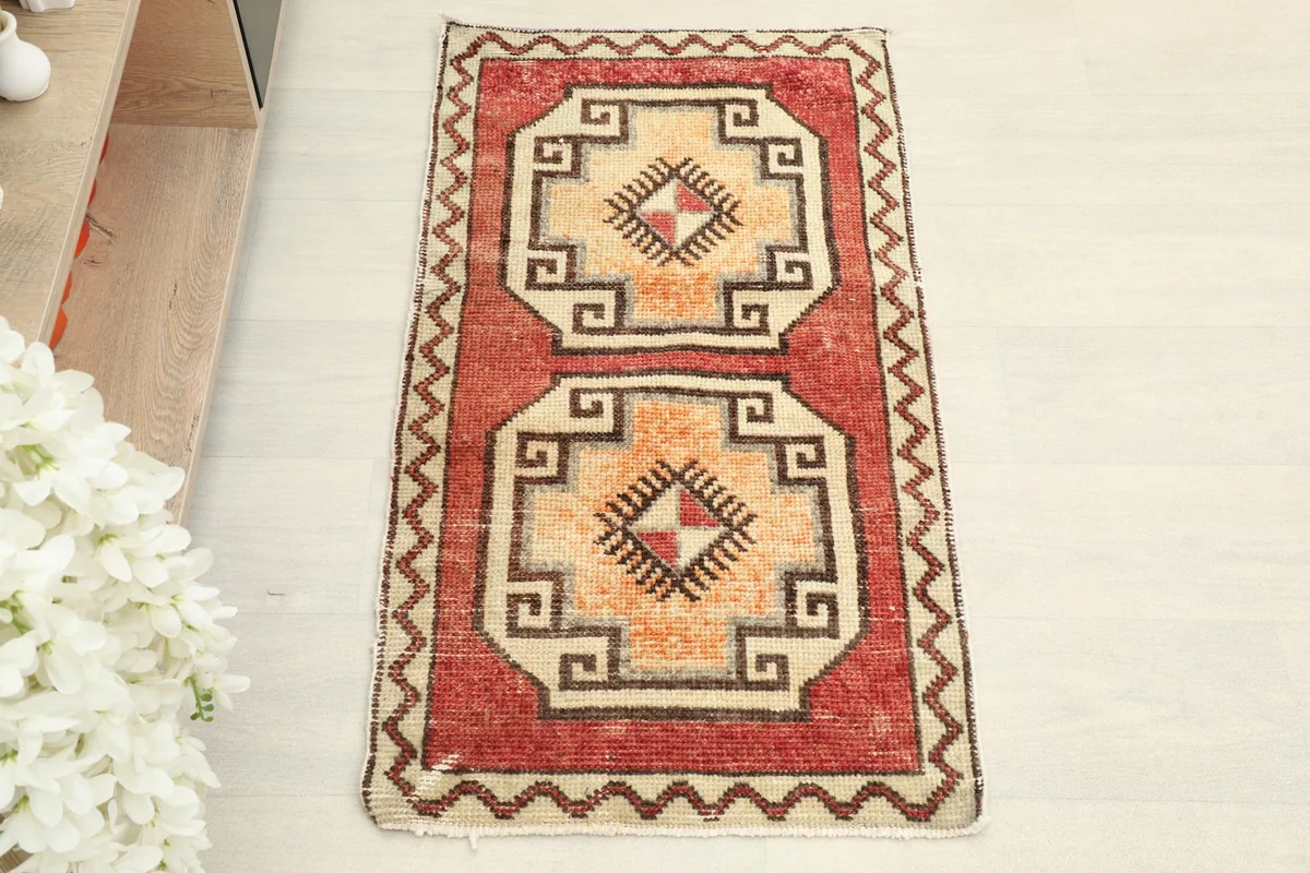 Full overhead view of the vintage Anatolian rug, showcasing its rust field and beige tribal motifs.