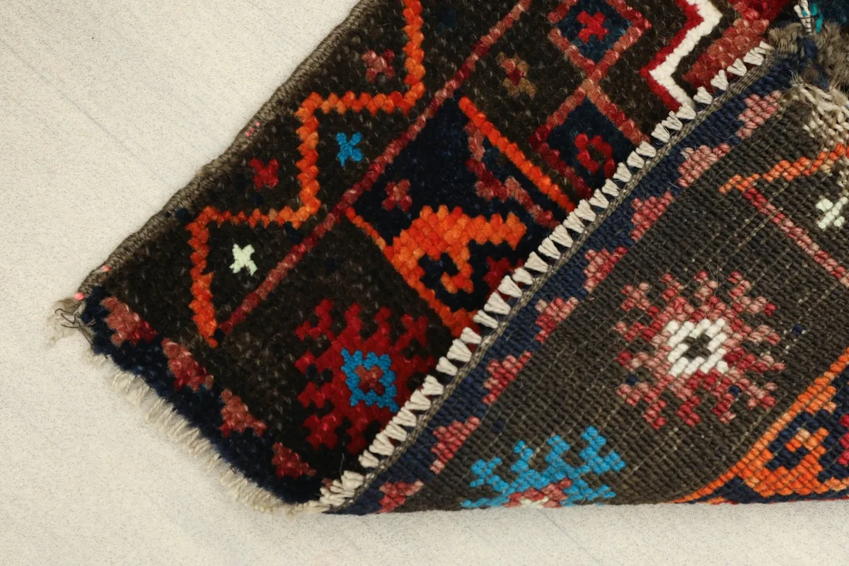 View of the rug's underside, revealing the hand-knotted cotton foundation