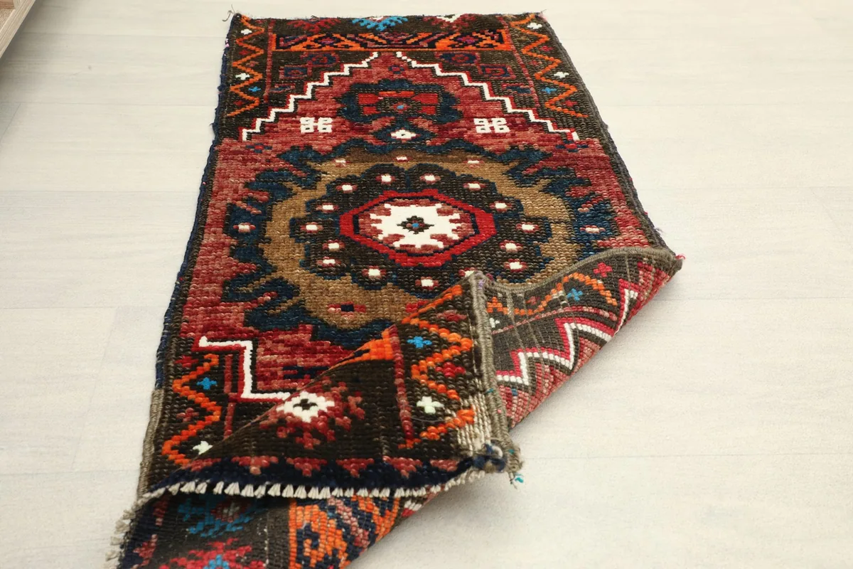 Rug folded to show its flexibility and the quality of the wool pile