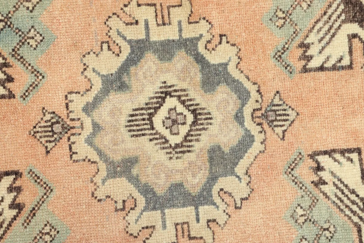 Detailed view of the hand-knotted wool pile and the intricate central design