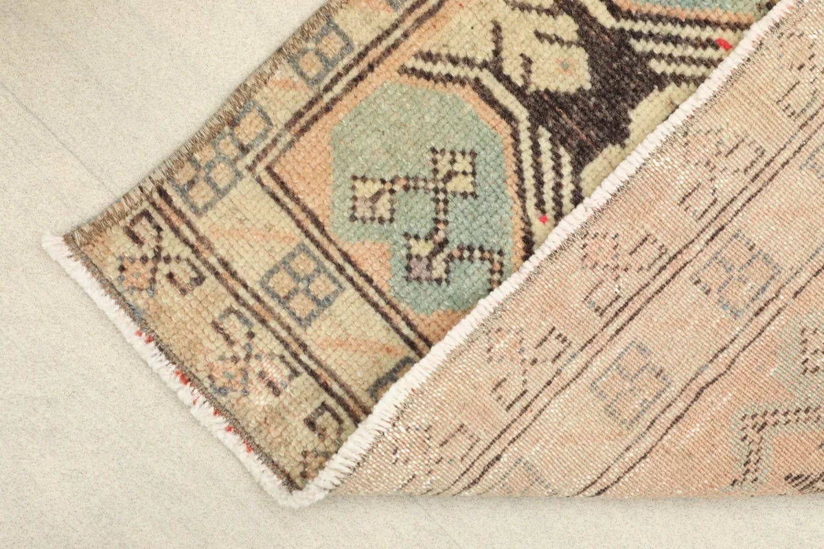 View of the rug's back, showcasing the tightly woven cotton foundation and knotting