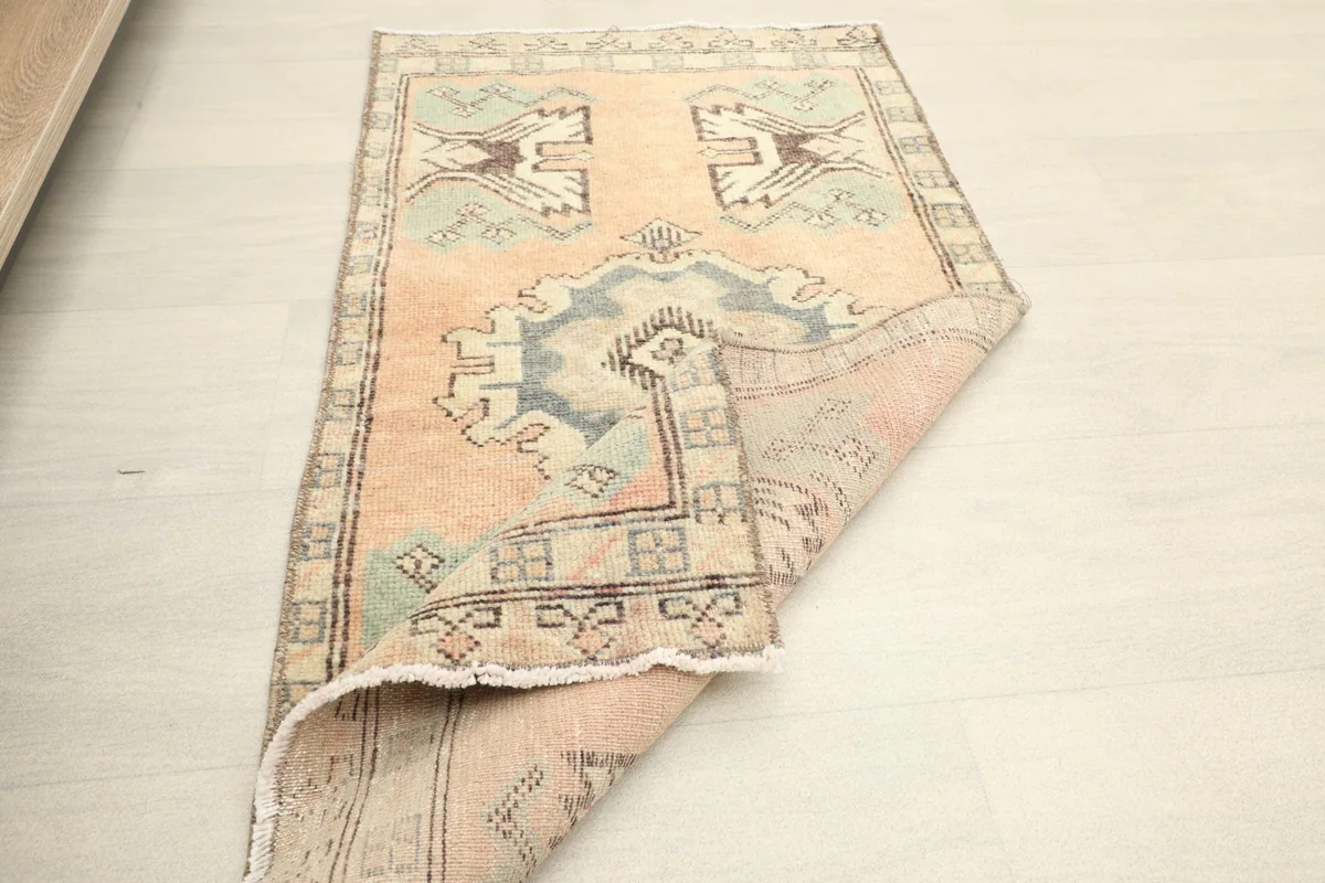 The rug folded to show its flexibility and thickness of the low pile