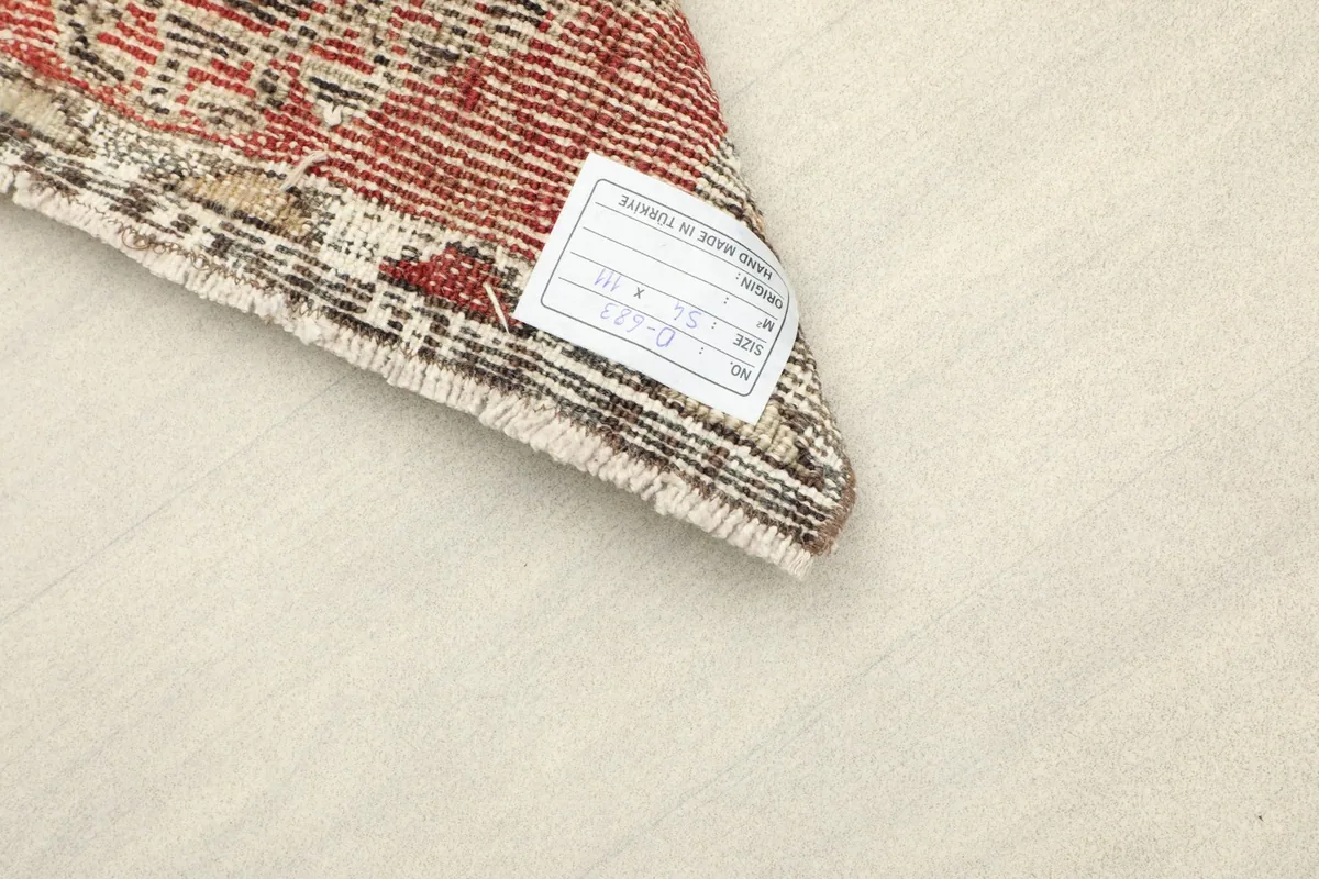 Close-up of the back of the rug, showing the cotton foundation and a product label.
