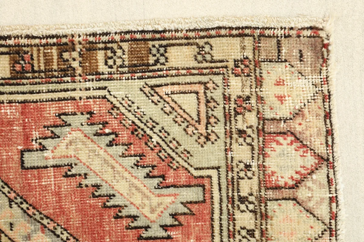 Close-up of a rug corner, highlighting the intricate border designs and color variations.