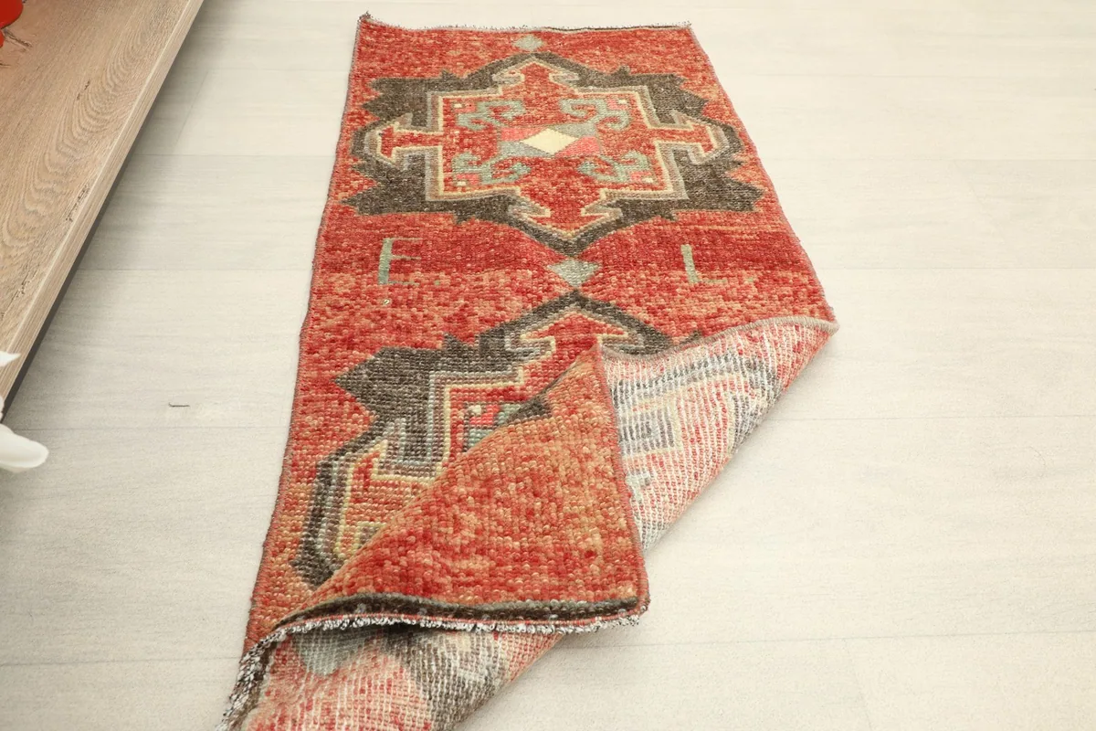 The doormat partially folded, displaying its flexibility and the overall design.