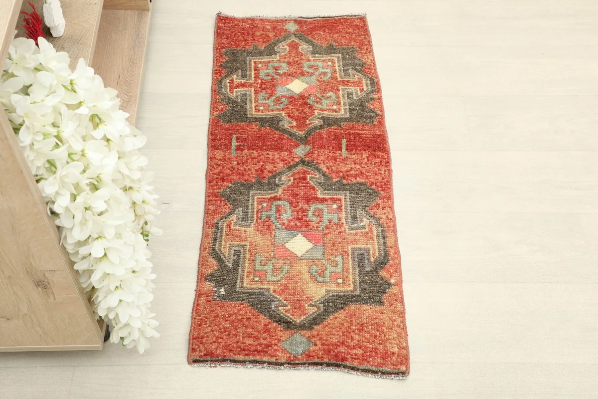 Overhead view of the hand-knotted vintage Anatolian rug, highlighting its rustic red and charcoal patterns.