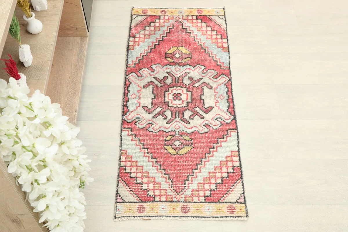 Overhead view of the vintage Anatolian rug, showcasing its rose field and central cream and rose medallion.