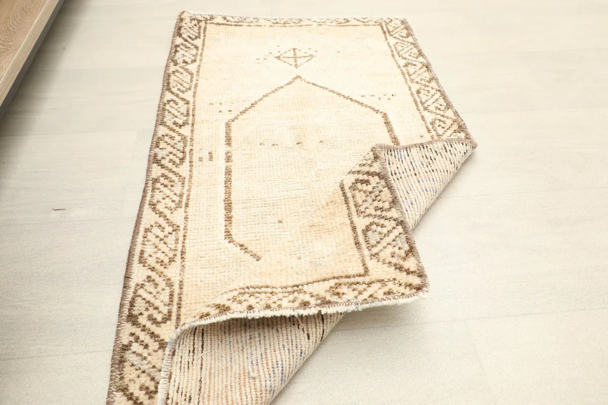 The vintage doormat folded to display its flexibility and the reverse side