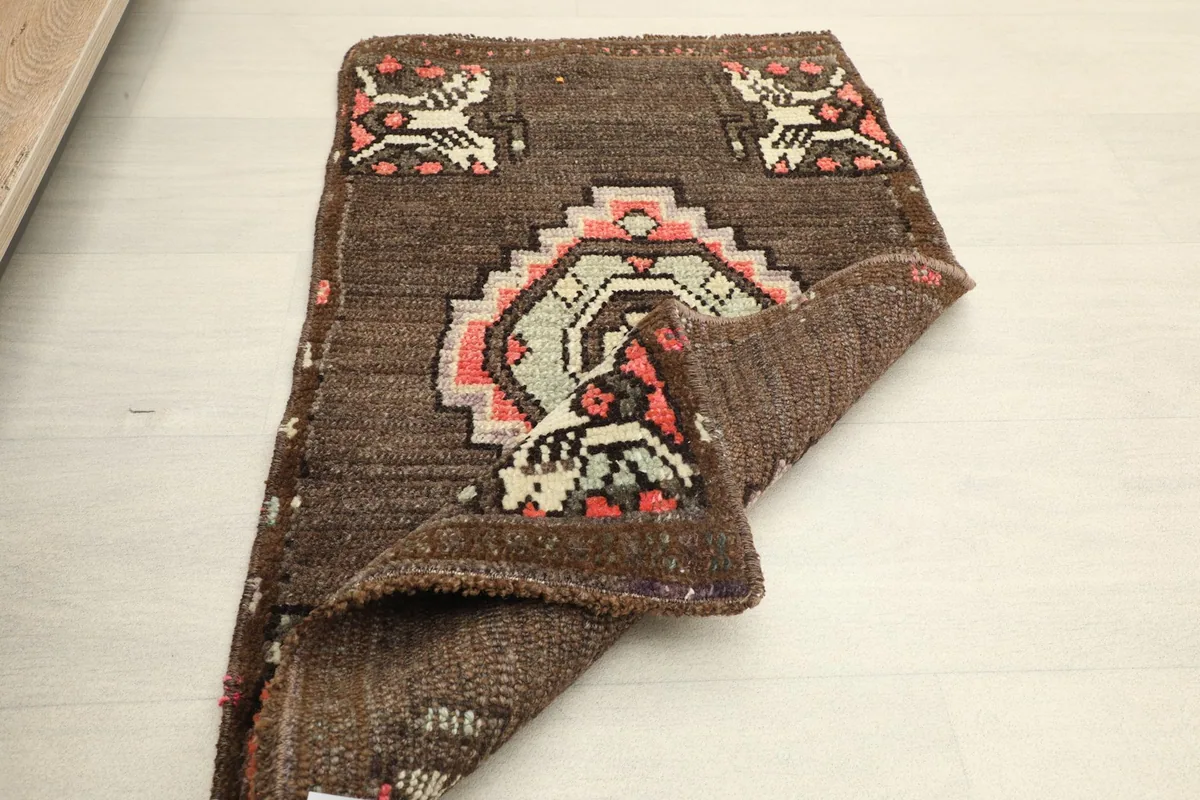 Another folded perspective, illustrating the rug's flexibility and the depth of its brown color.