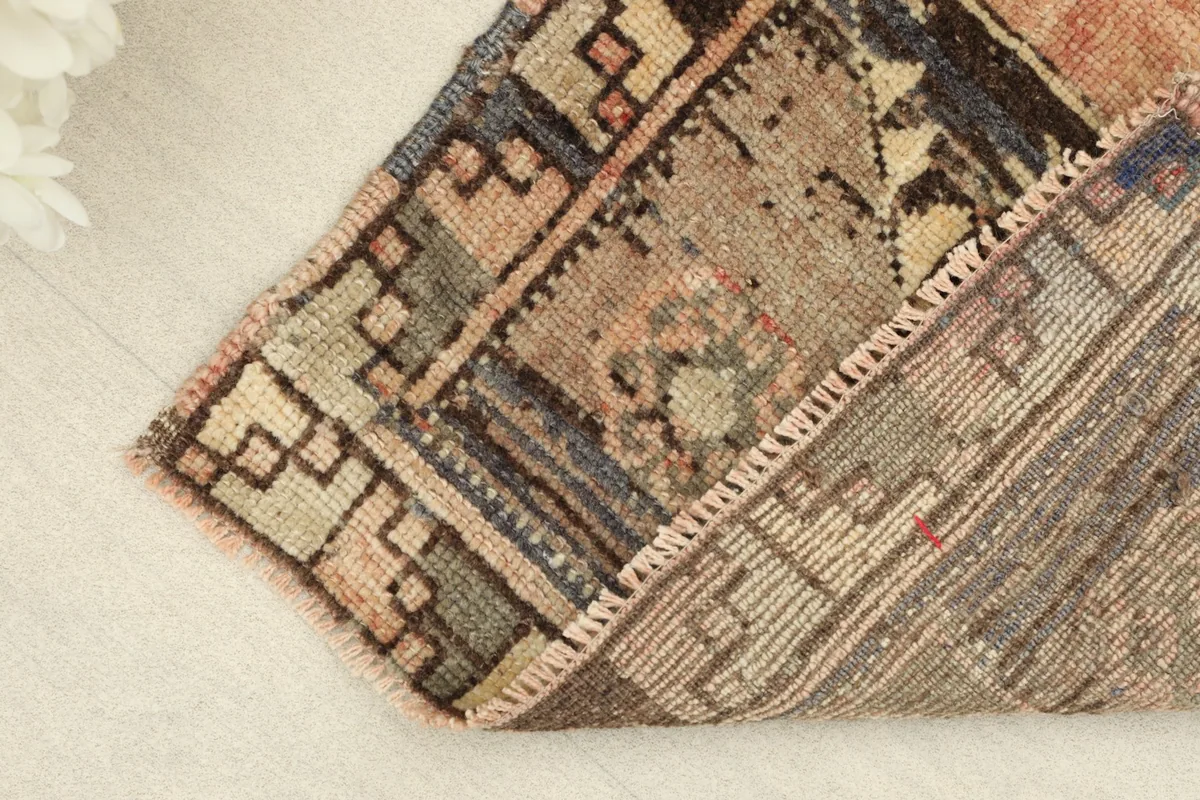 View of the rug's underside, revealing the cotton foundation and hand-knotted construction.