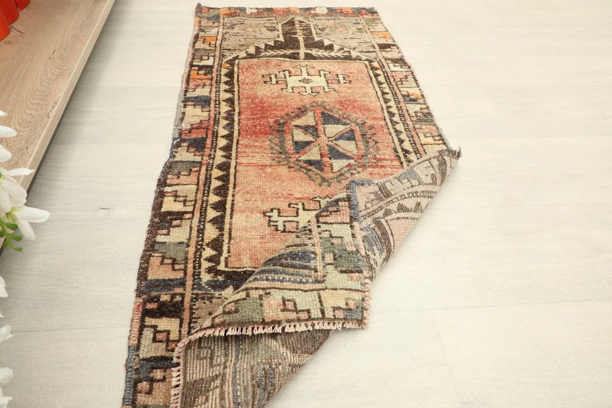 The rug folded to show its flexibility and thickness, highlighting its vintage character.