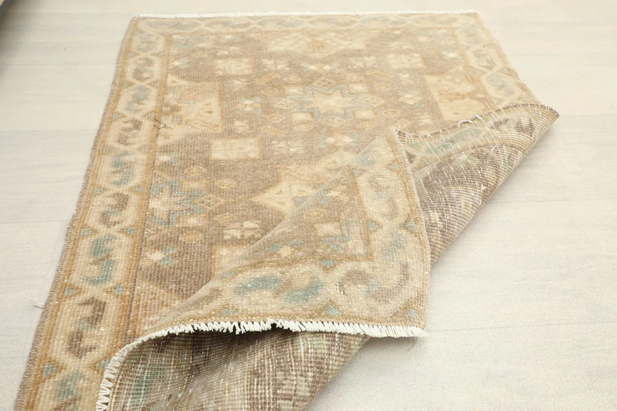 Rug folded to show the thickness of the wool pile and the texture of the back