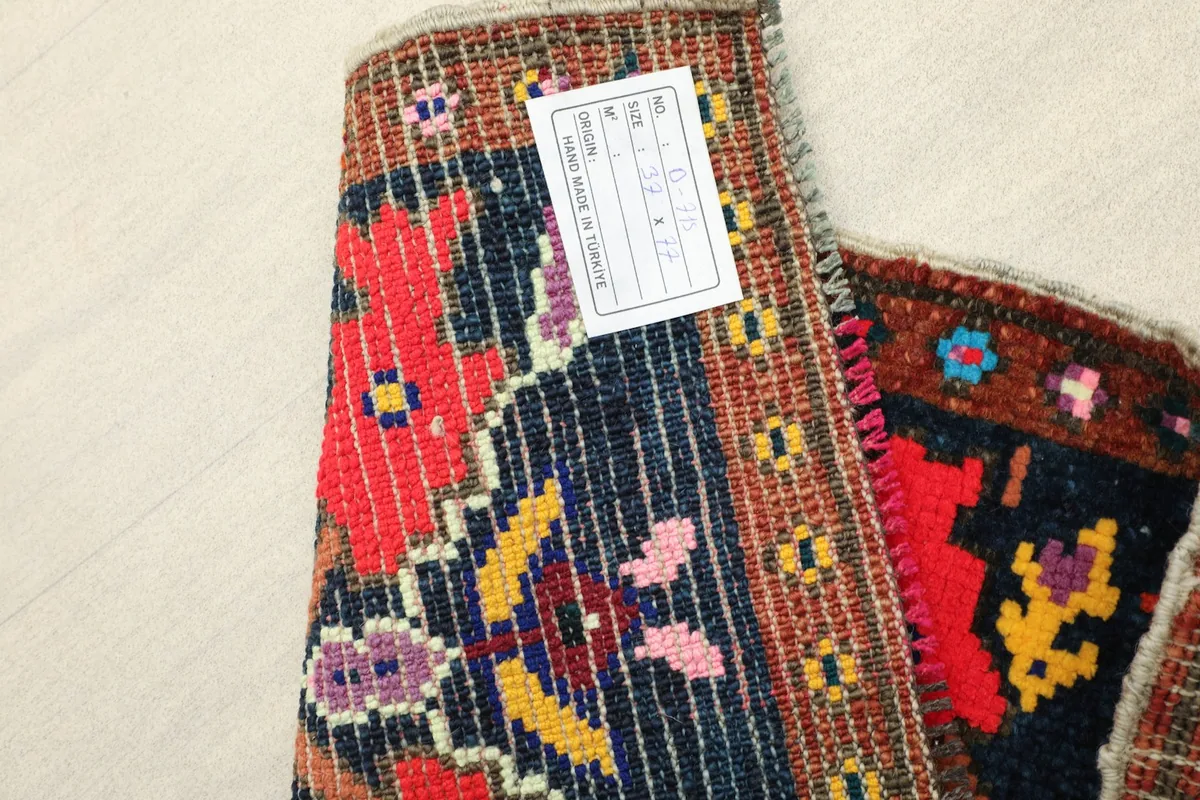 Close-up of the rug's back, displaying the hand-knotted construction and foundation