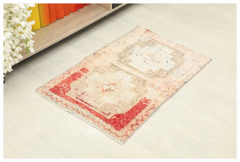 Full top view of the beige and rust geometric vintage Anatolian doormat on a white background.