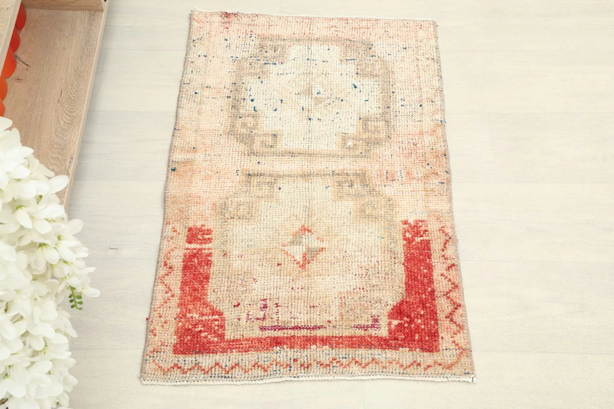 Overhead view of the hand-knotted vintage rug, showing its overall geometric design and color variation.