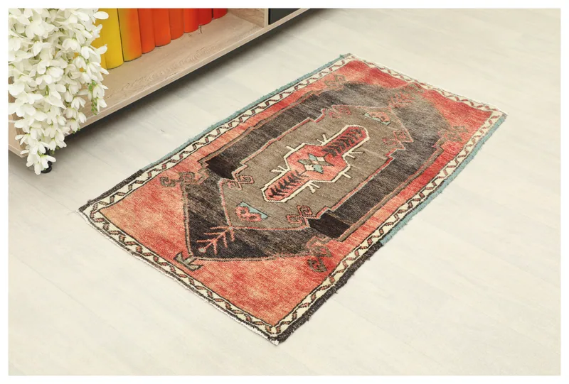 Full top view of the red and brown vintage Anatolian doormat on a white background.