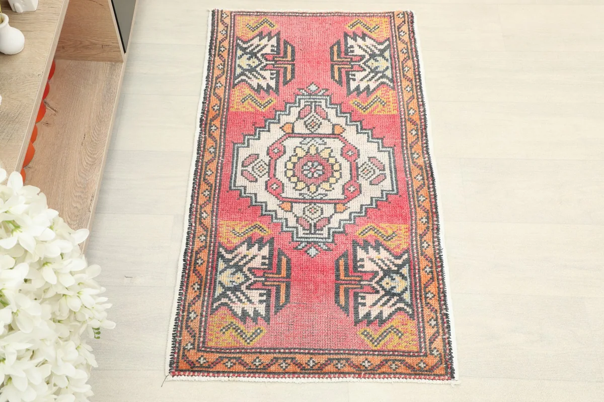 Overhead view of the vintage Anatolian rug, highlighting its rose field and detailed patterns