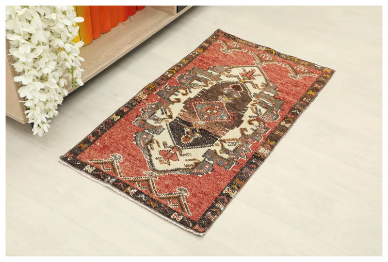 Full top view of the vintage rust and cream geometric Anatolian wool rug on a white background.