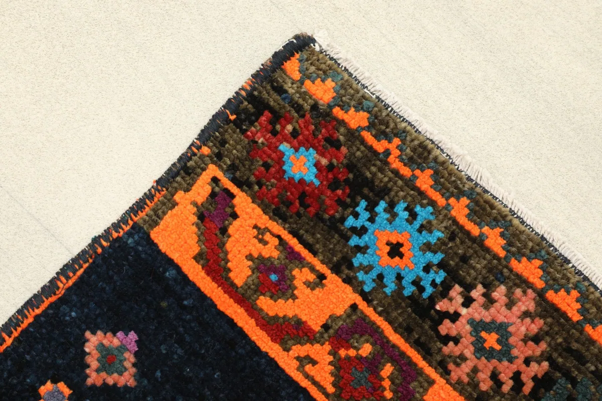Corner detail showing the navy border with orange and blue geometric elements.