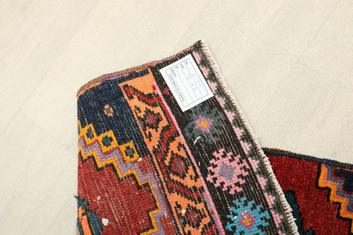 View of the back of the runner, indicating its hand-knotted quality and showing the tag.