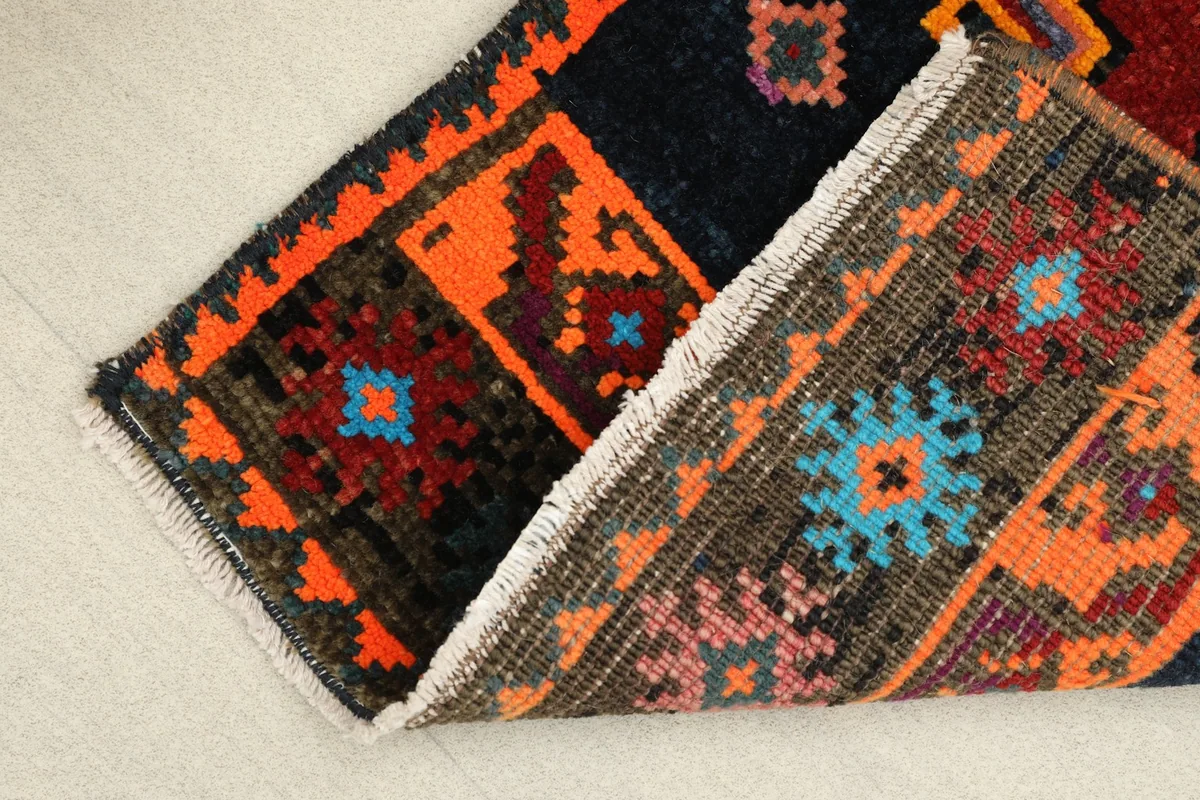 Folded corner of the runner, showing the wool pile and cotton foundation.