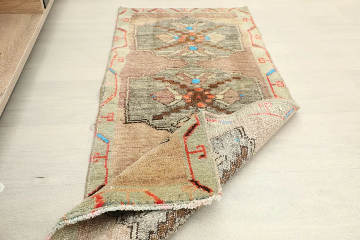 View of the runner partially folded, revealing the reverse side and the hand-knotted cotton foundation.