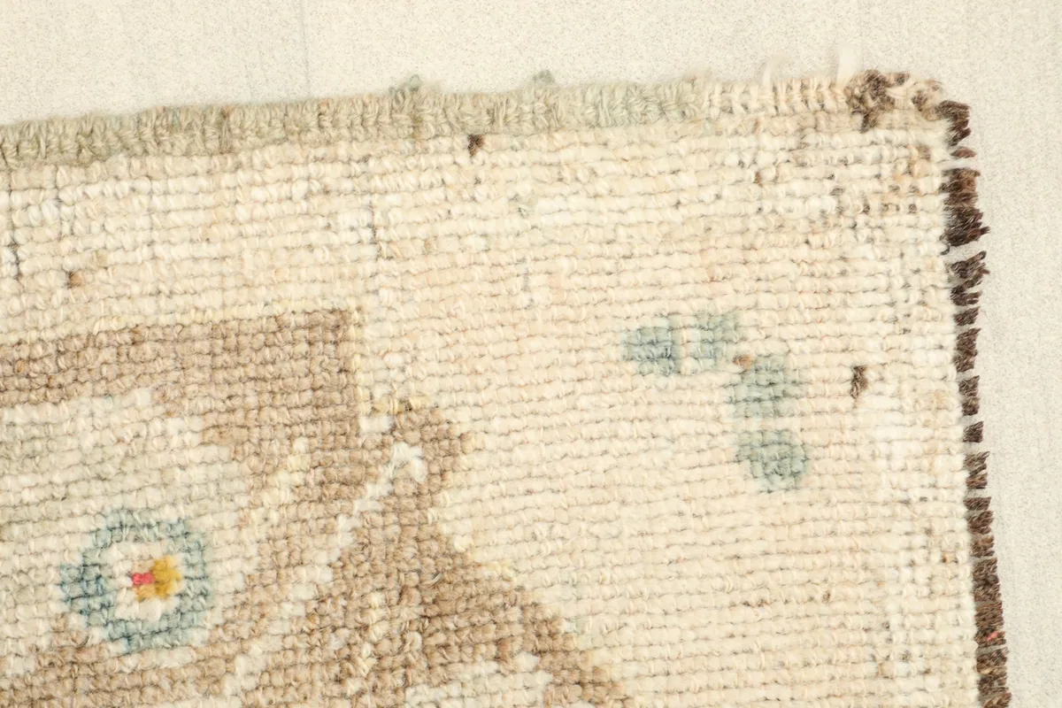Close-up of the low wool pile and the tightly woven edge of the vintage Anatolian rug