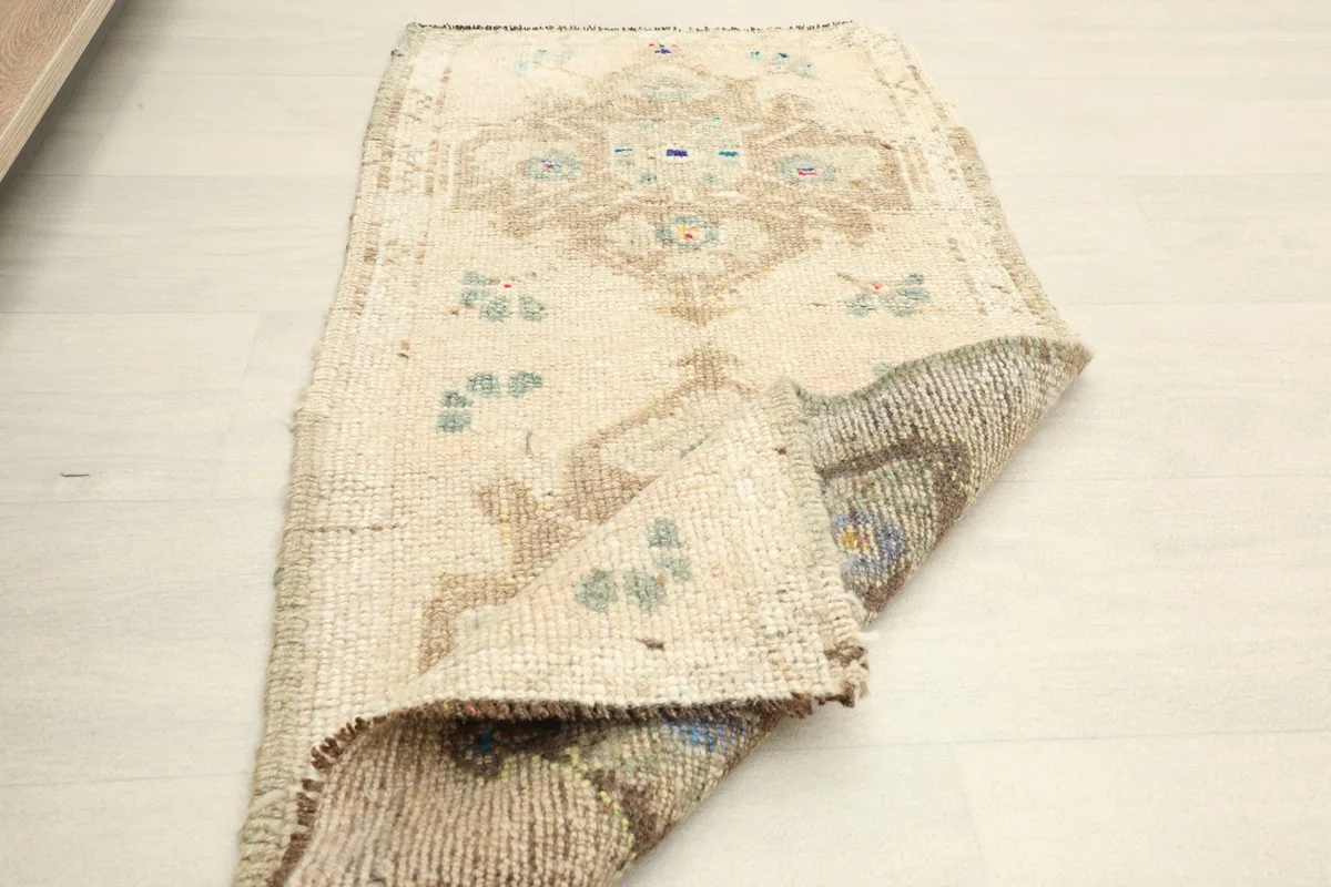 Partial view of the rug with a section folded, revealing the back and front textures
