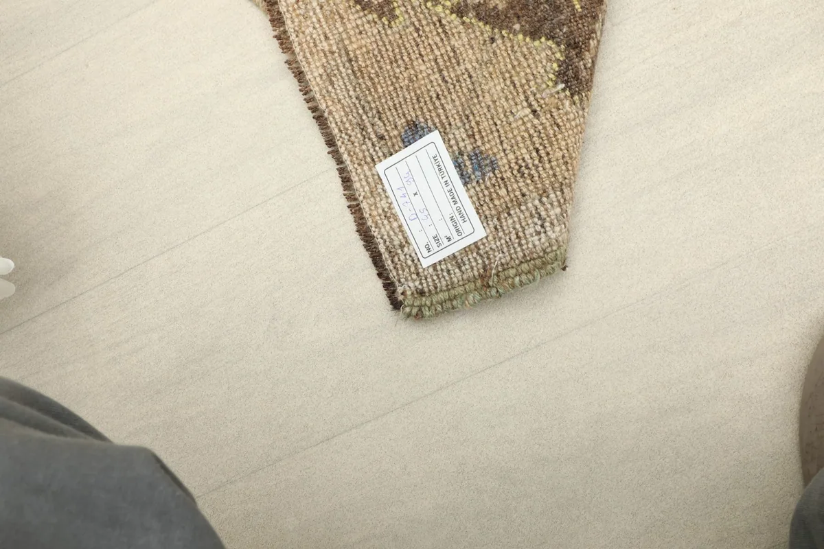 View of the rug's label on the back, providing details about its origin and material