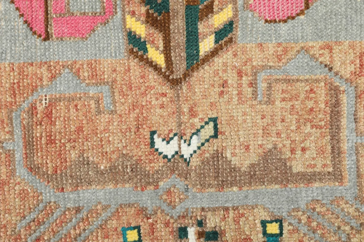 Detailed view highlighting the intricate geometric patterns and color variations within the rug's design.