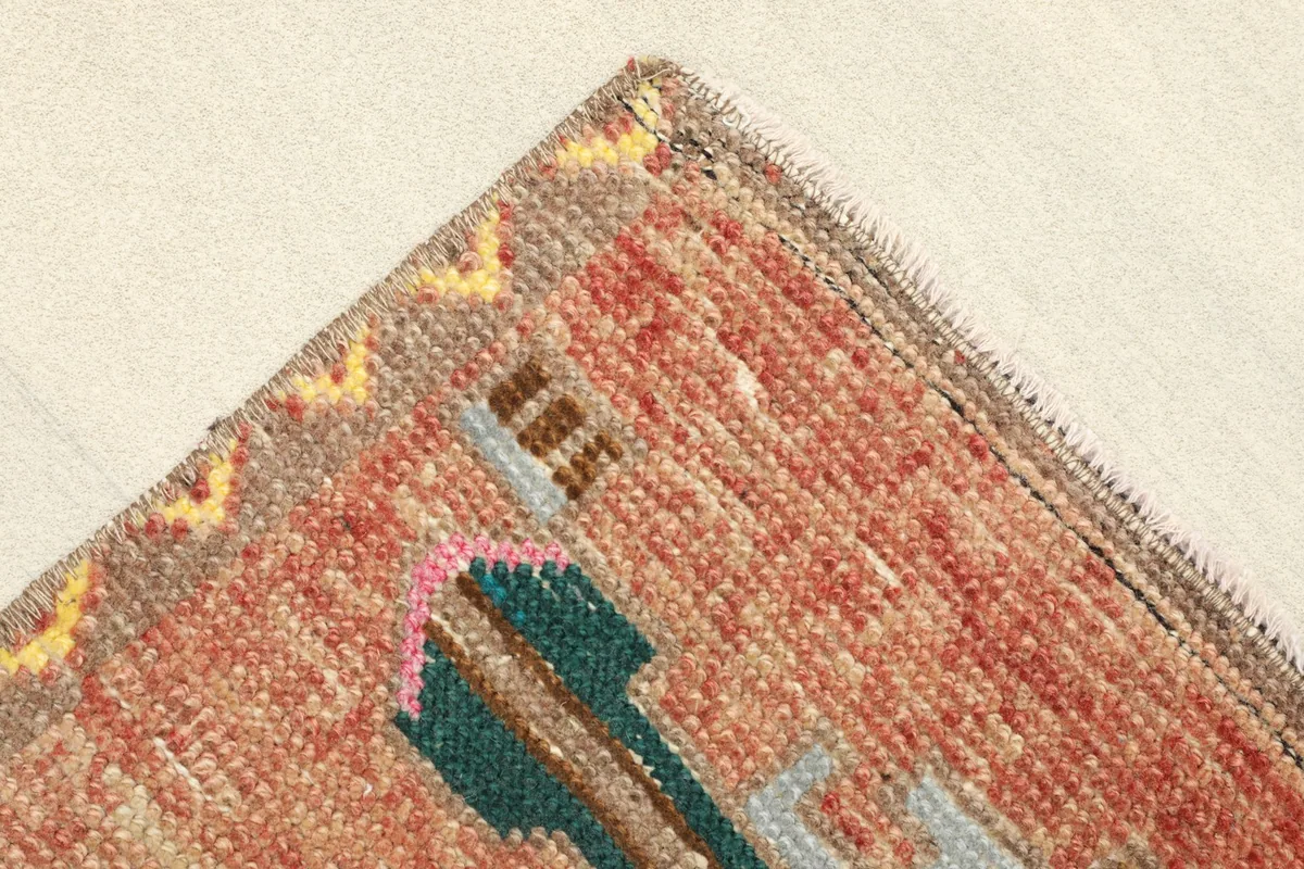 Corner detail of the rug, showing the border design and the quality of the hand-knotted wool.