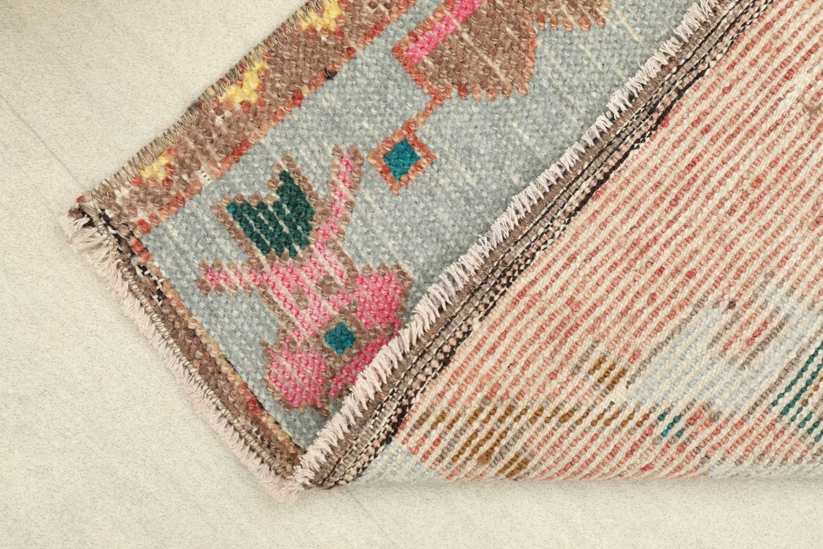 View of the rug's reverse side, revealing the cotton foundation and fine hand-knotting.
