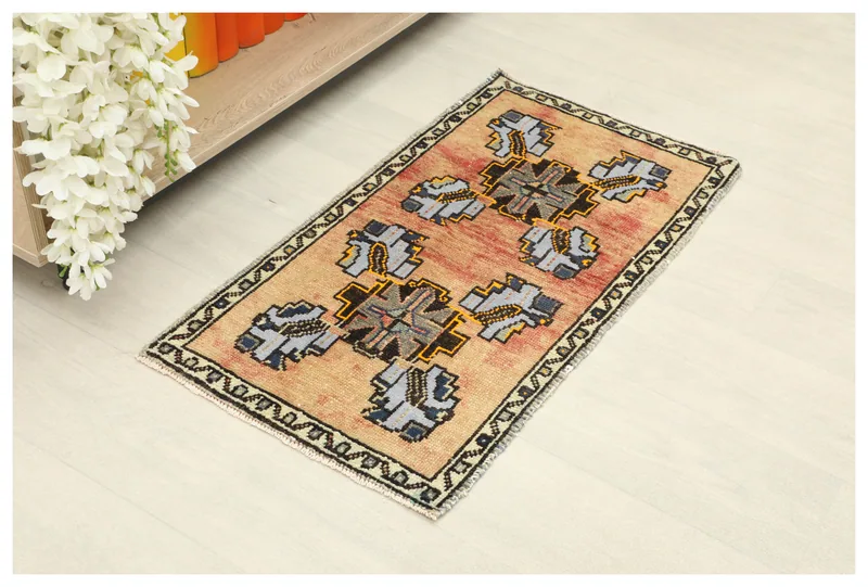Full top view of the beige and red geometric Anatolian rug on a light floor.