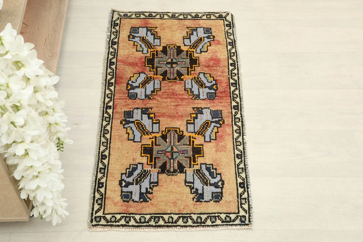 Overhead view of the hand-knotted vintage rug, showing its full design and colors.