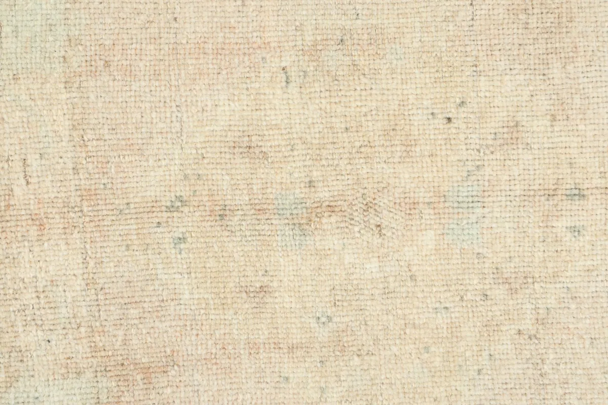 Detailed texture of the low wool pile, showing the hand-knotted construction and distressed character.