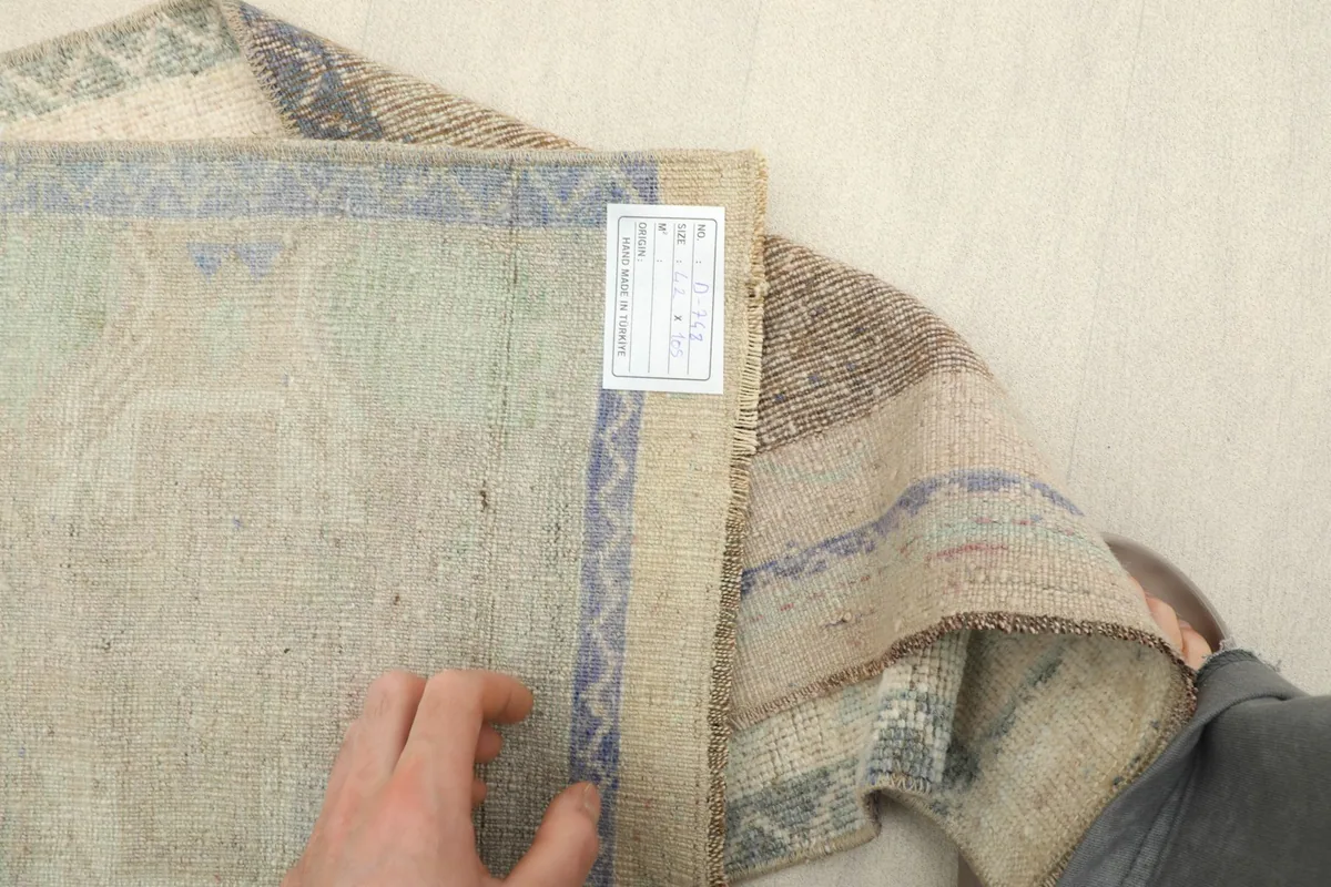 Underside of the hand-knotted rug, revealing the cotton foundation and construction details.