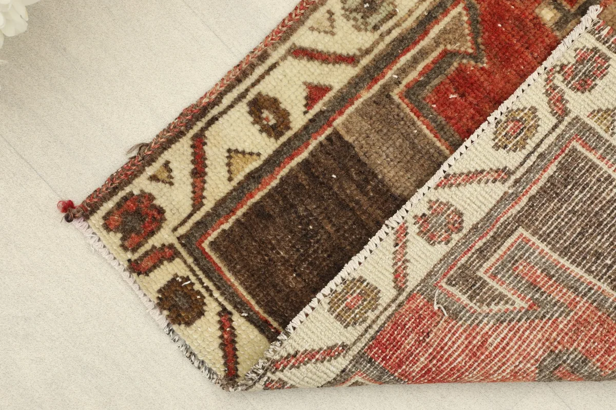 Rug folded to show the back of the hand-knotted cotton foundation and the wool pile
