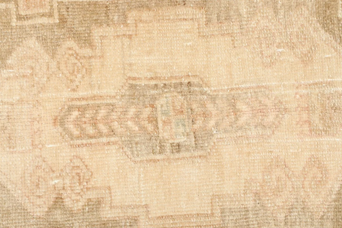 Close-up detail of the central motif, showing the intricate geometric patterns and wool texture.
