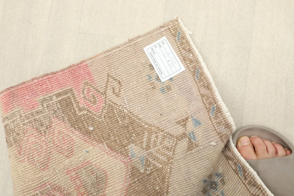 Back of the rug showing the hand-knotted construction and cotton foundation.