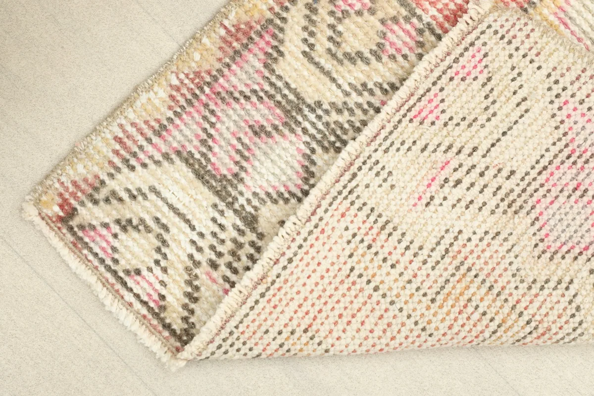 View of the back of the hand-knotted rug, revealing the cotton foundation and fine knotting detail.