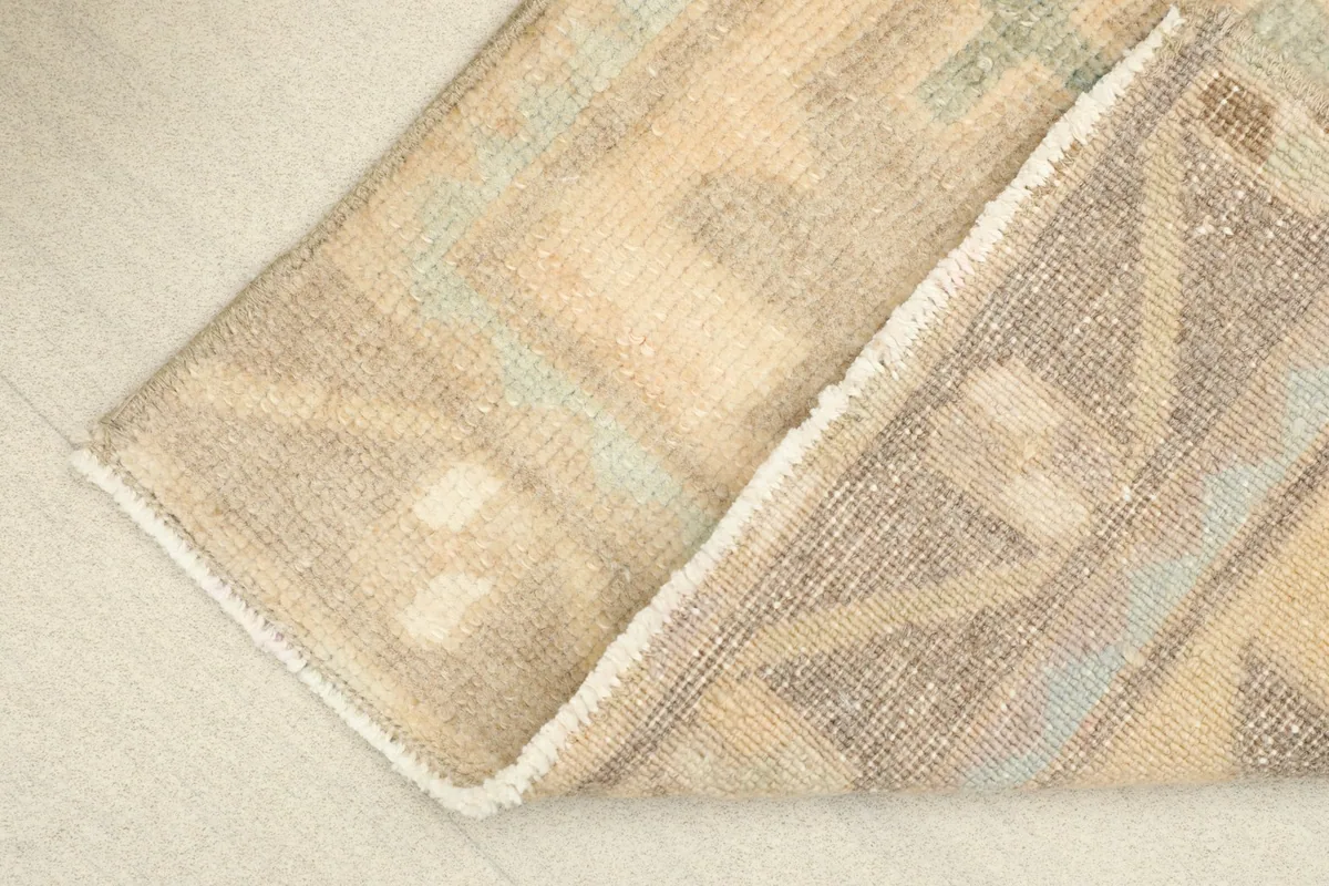 Folded corner revealing the low wool pile and cotton foundation