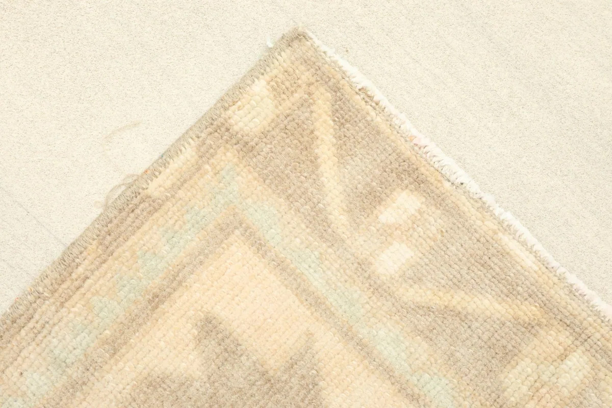 Corner detail showing the subtle color variations and craftsmanship of the rug