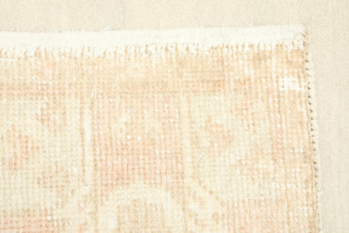 Close-up of a corner of the rug, highlighting the subtle color variations and edge finishing.