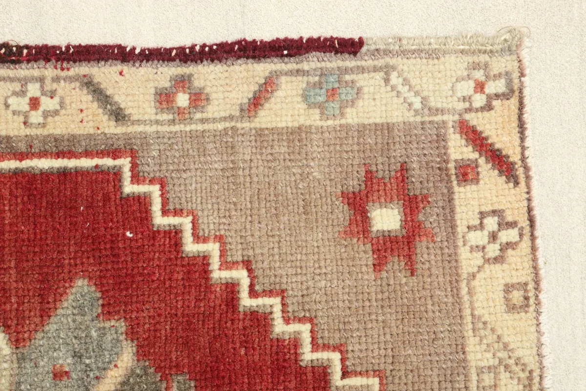 Close-up of the rug's edge, showcasing the stepped pattern and color variations