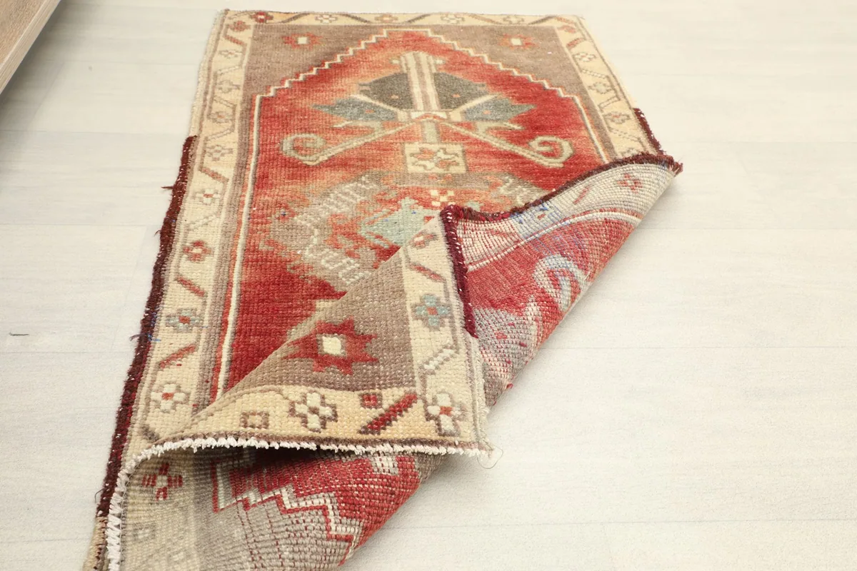 Angled shot of the rug partially folded on the white floor
