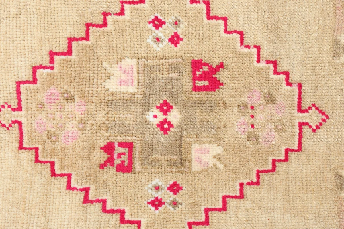 Close-up detail of the hand-knotted wool pile and intricate geometric motifs