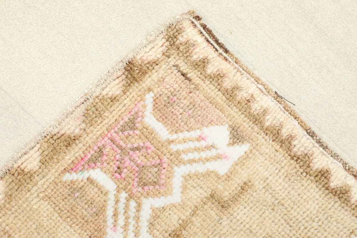 Corner detail showing the patterned border and tight weave of the rug